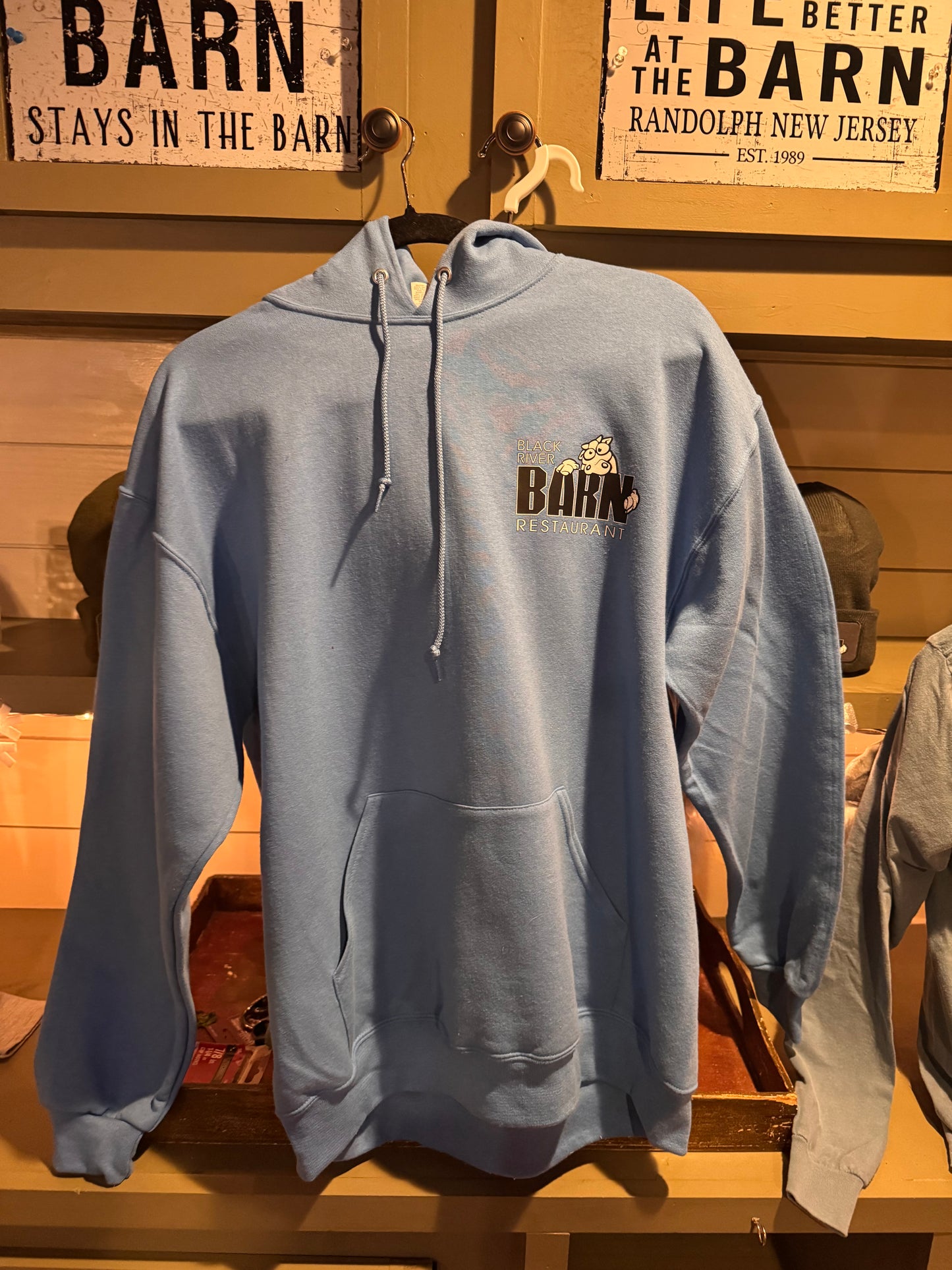 Light blue Black River Barn restaurant hoodie with logo on the front, soft heavyweight fabric, casual fit