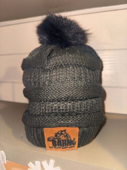 Gray knit Black River Barn pom beanie with logo patch and pom on top
